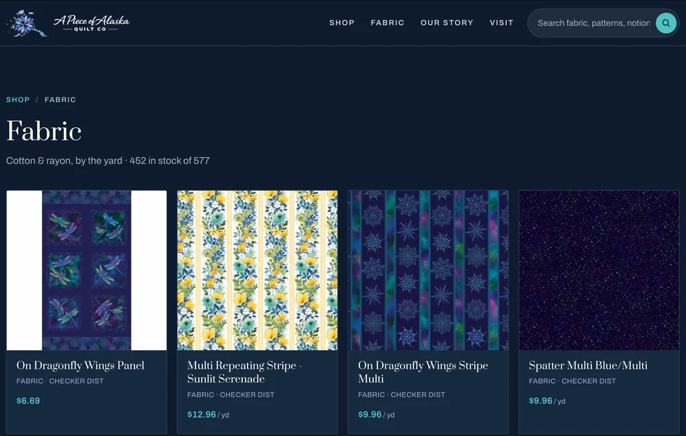 A Piece of Alaska Quilt Co.'s fabric shop: fabrics priced by the yard, with a note that 452 of 577 are in stock